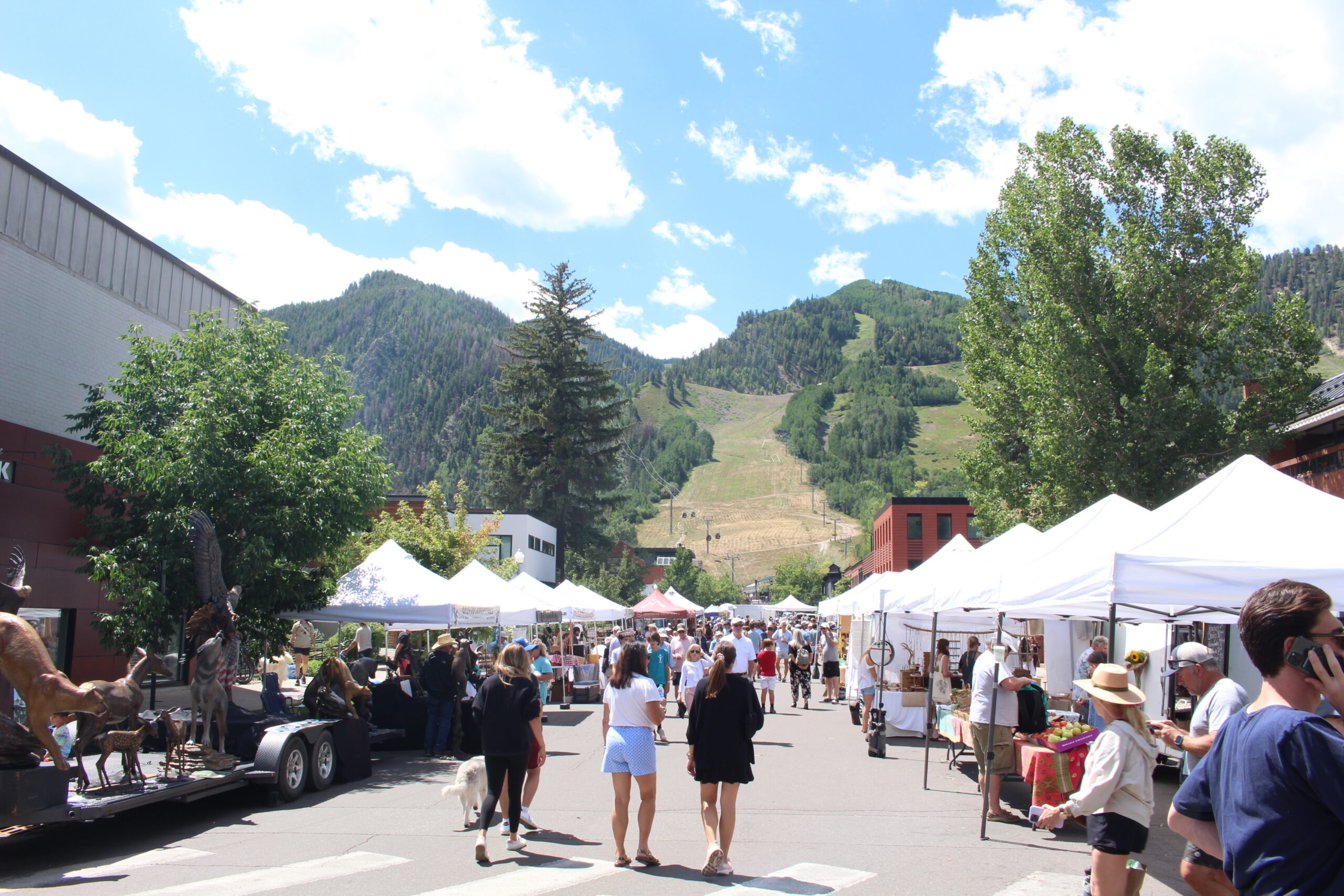 Visitors shopping at the Saturday Farmers Market during summer in Aspen